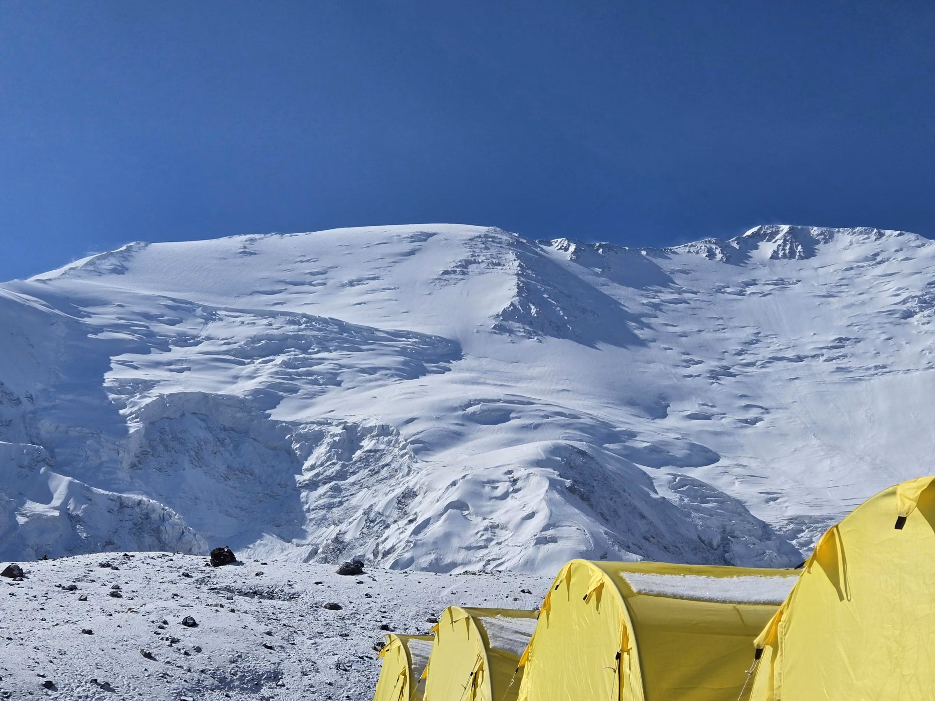 Mountain camps with snowy Himalayan peaks in the background