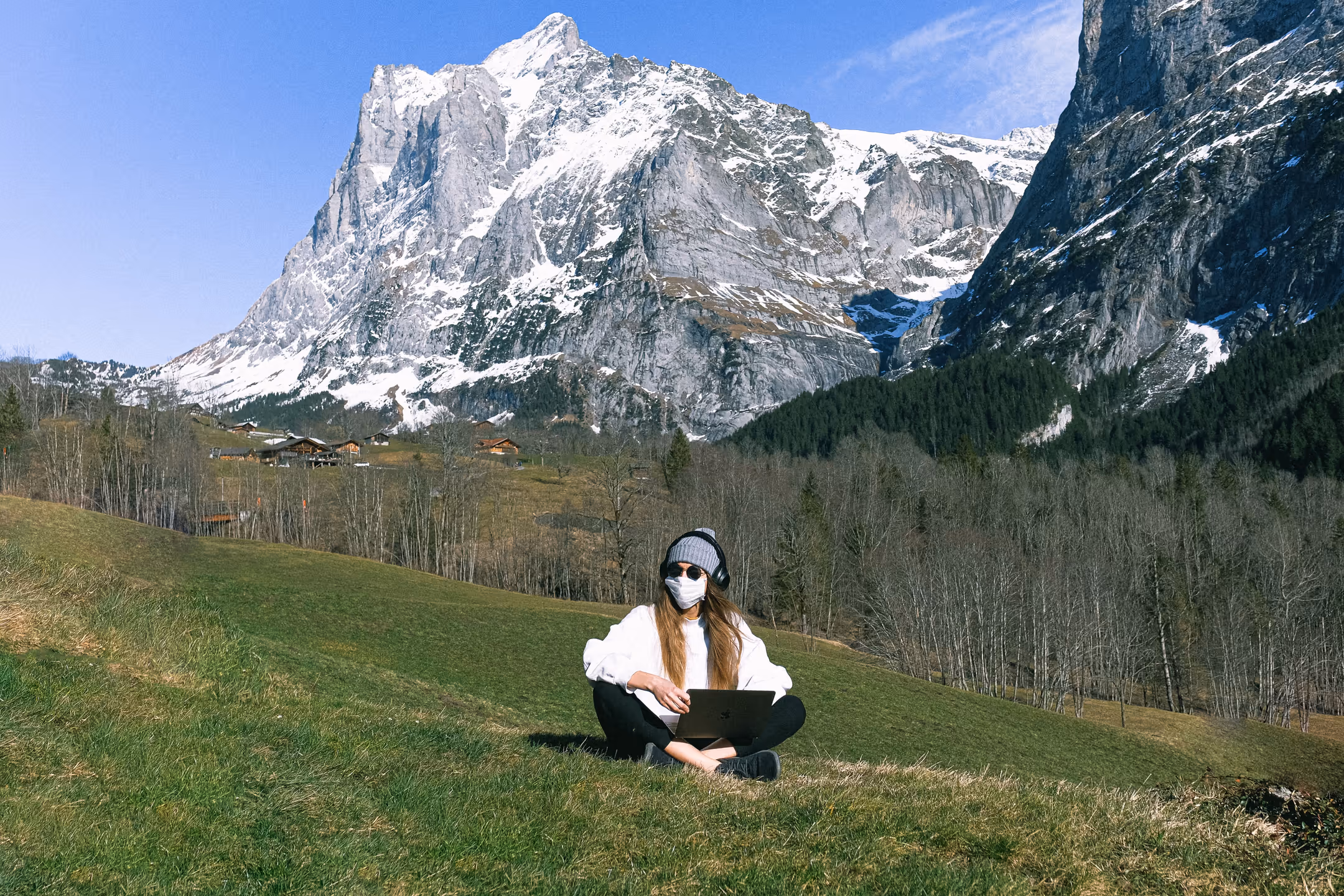 A woman working from a hilltop with a mountain view in Nepal