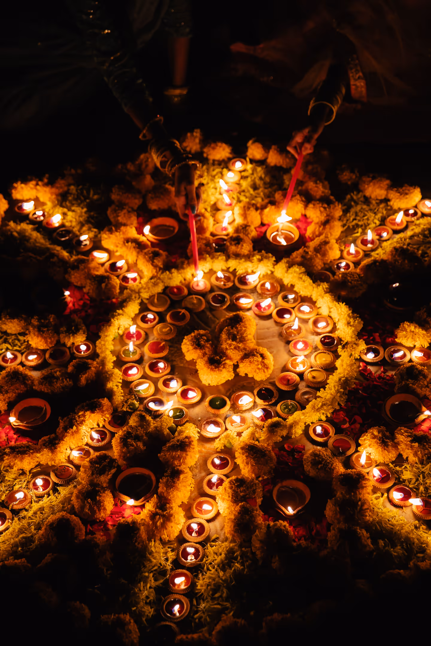 Rows of traditional oil lamps lit in sequence during Tihar festival