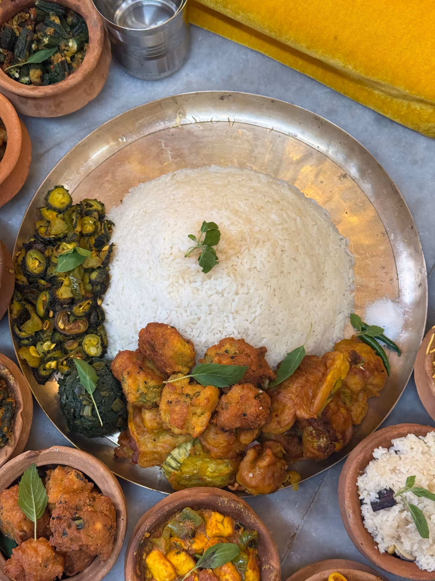 A spread of Nepali food served in traditional pottery