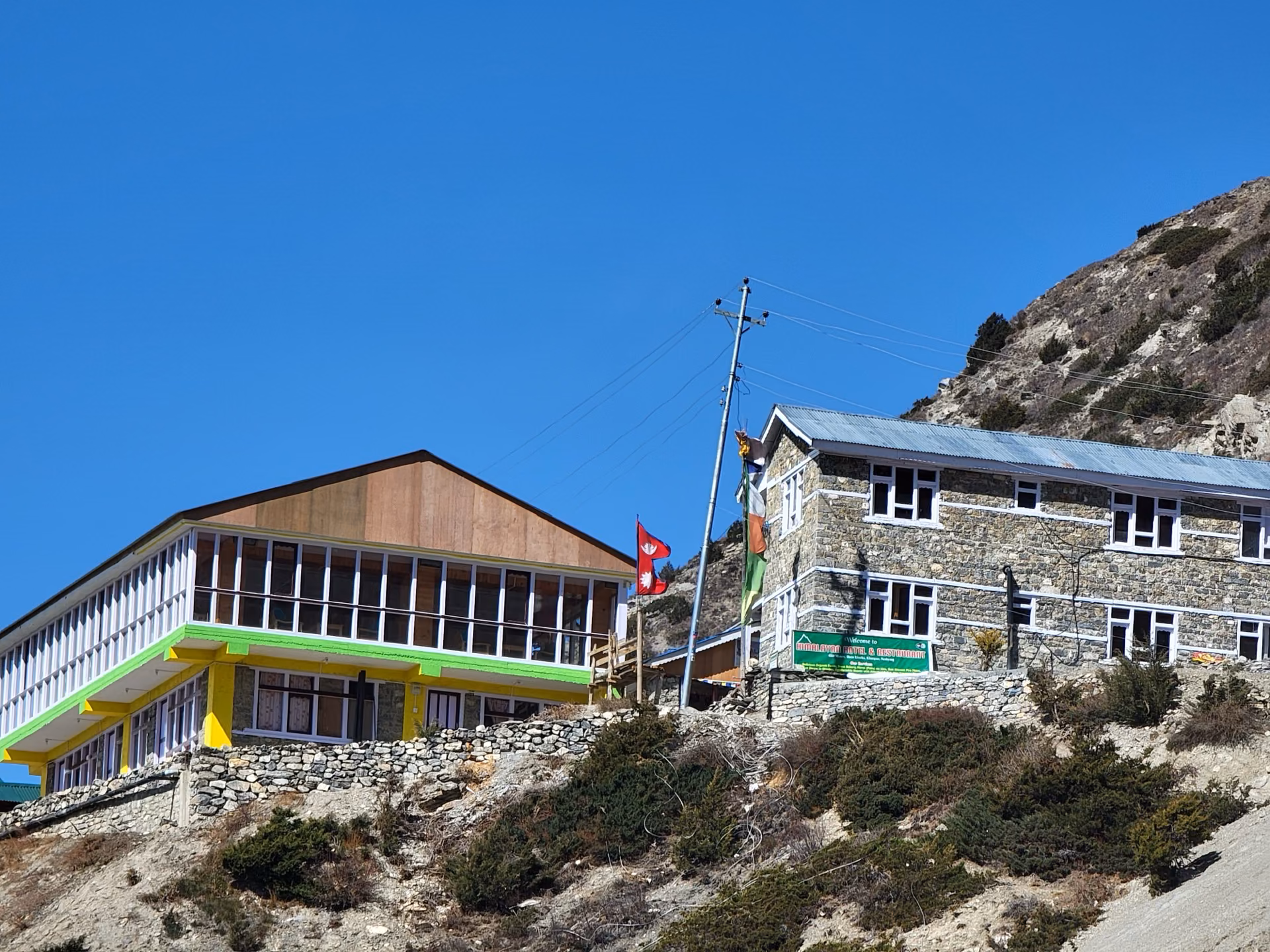 A cozy tea house on the trekking route with mountain backdrop