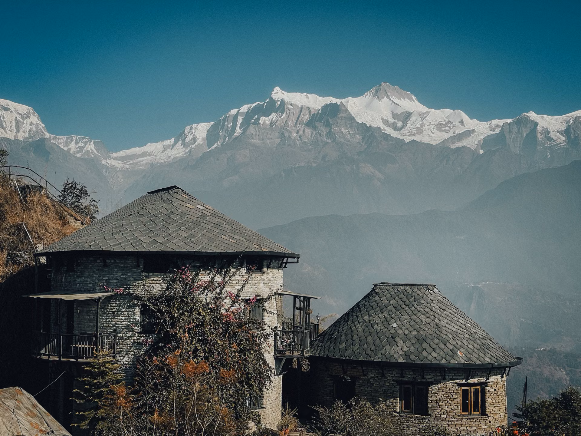 Snow-covered tea houses with dramatic mountain peaks in the background