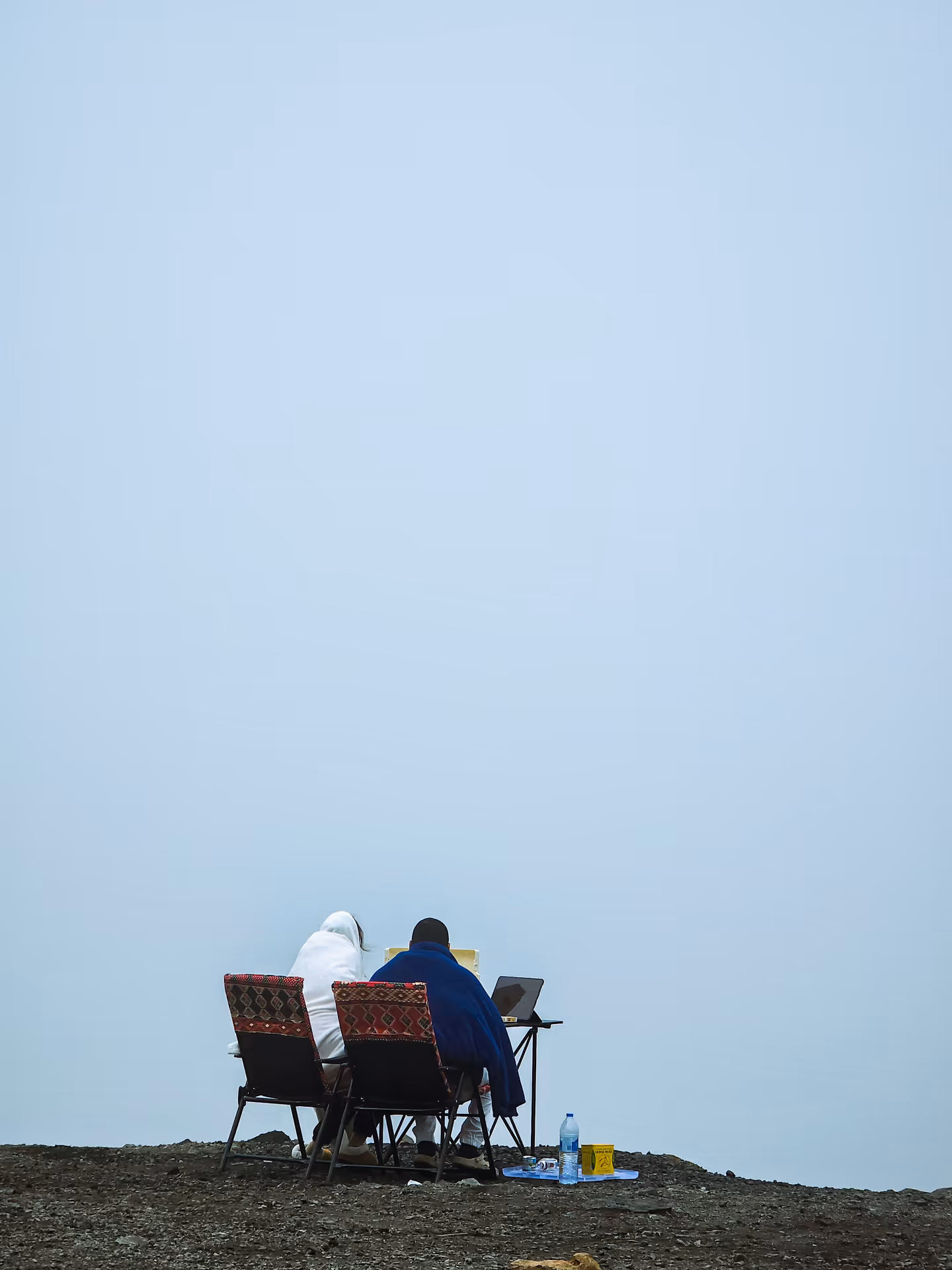 Two people working remotely from a hilltop in Nepal